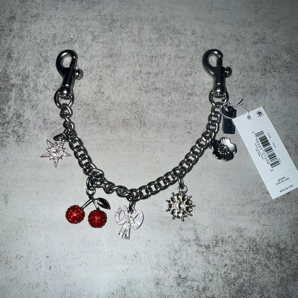 Coach silver crystal charm strap with red cherry and star charm